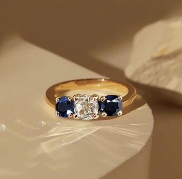 1+1 Offer: Golden Three Stone Cushion Cut White & Blue Sapphire Wedding Band Ring for Women + Round Cut White Sapphire Gold Necklace
